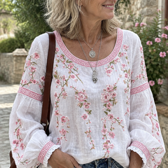 Woman wearing the white floral embroidered blouse