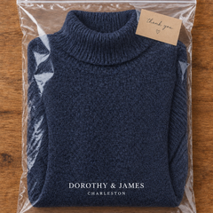 Navy blue turtleneck sweater folded in Dorothy & James Charleston packaging