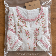White floral blouse folded in Dorothy & James Charleston packaging
