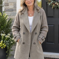 Woman wearing the Isola knit sleeve double-breasted coat outdoors