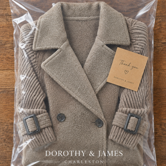 Isola coat folded in Dorothy & James Charleston packaging