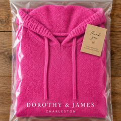 Chloe pink poncho sweater folded in Dorothy & James Charleston packaging