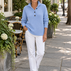 Woman wearing the Florence sky blue V-neck polo sweater with white jeans