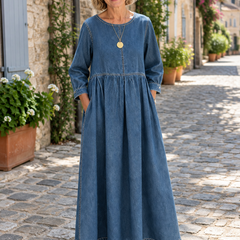 Woman wearing the Anna vintage denim maxi dress on a cobblestone lane