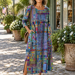 Woman wearing the Manuela patchwork maxi dress with three-quarter sleeves on a sunny street