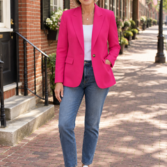 Woman wearing the Linda pink one-button blazer with jeans on a historic street
