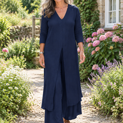 Woman wearing the Carmella navy two-piece tunic and wide-leg pants set in a garden