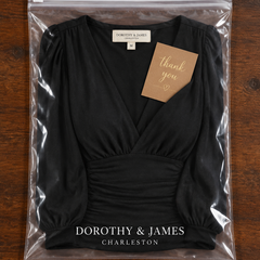 Loravine V-neck top folded in Dorothy & James Charleston packaging with thank you card
