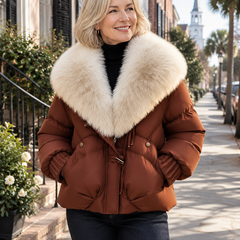 Woman wearing a rust-brown puffer coat with a cream faux-fur collar