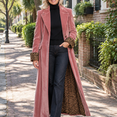 Woman in a floor-length dusty rose velvet tailored coat with leopard-print cuffs and lining