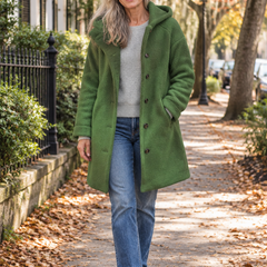 Woman in her 60s wearing the Camille green fleece hooded button-front coat on an autumn Charleston street