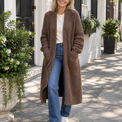 Woman wearing the Alice brown longline chunky knit cardigan with jeans on a Charleston sidewalk