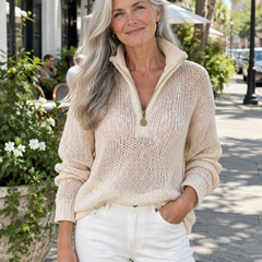Woman wearing the beige half-zip knit sweater with white jeans