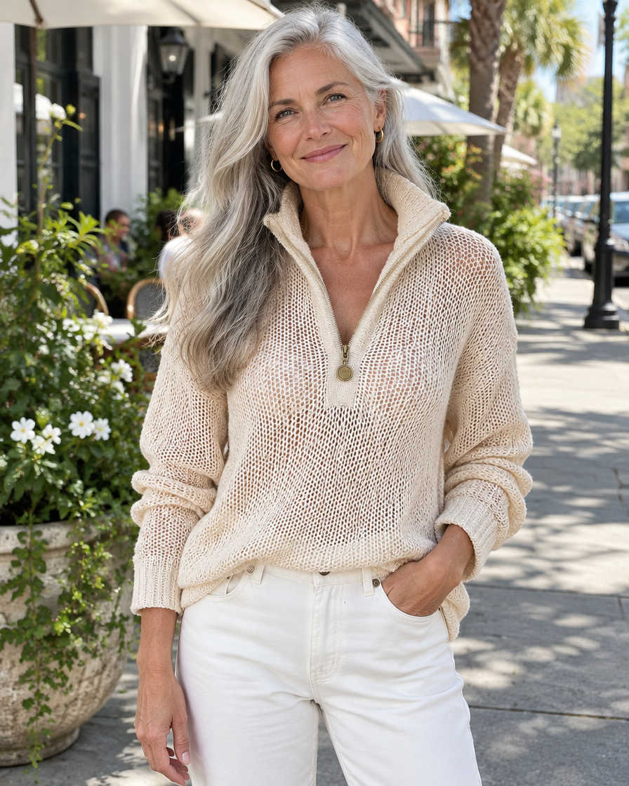 Woman wearing the beige half-zip knit sweater with white jeans