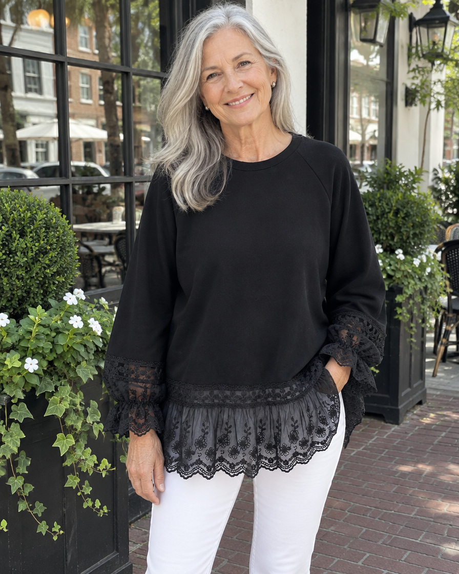 Woman wearing the black lace-panel sweatshirt with white jeans