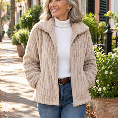 Woman wearing the cozy plush zip-up jacket over a white turtleneck