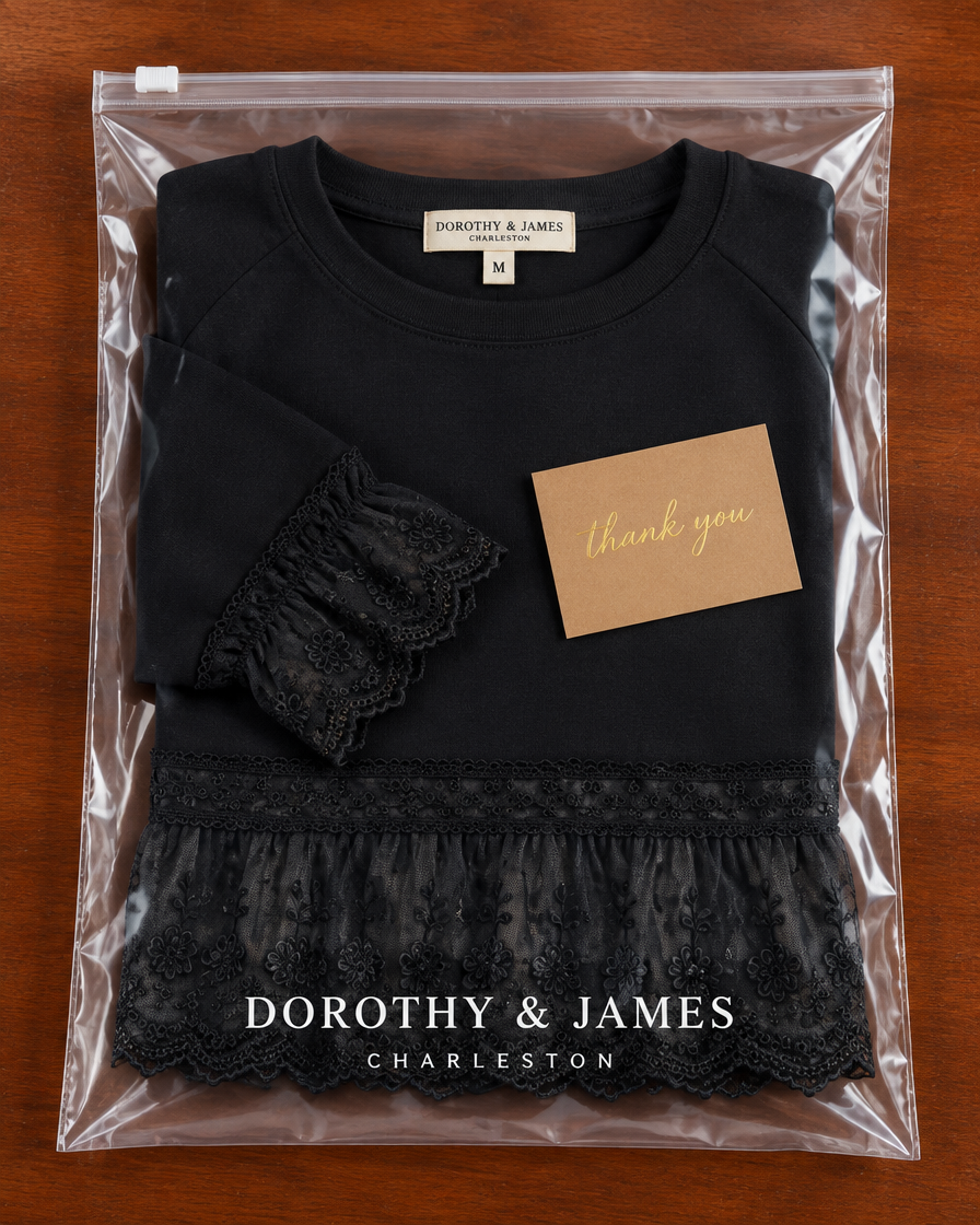 Black lace-panel sweatshirt folded in Dorothy & James Charleston packaging with thank you card