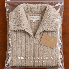 Cozy plush zip-up jacket folded in Dorothy & James Charleston packaging with thank you card
