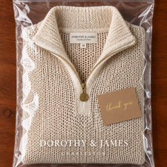 Beige half-zip knit sweater folded in Dorothy & James Charleston packaging with thank you card
