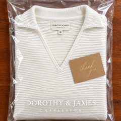 White V-neck sweater folded in Dorothy & James Charleston packaging with thank you card