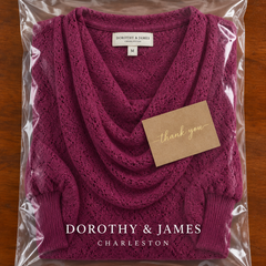 Wine red cowl-neck top folded in Dorothy & James Charleston packaging with thank you card