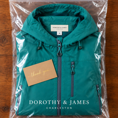 Hooded utility jacket folded in Dorothy & James Charleston packaging with thank you card