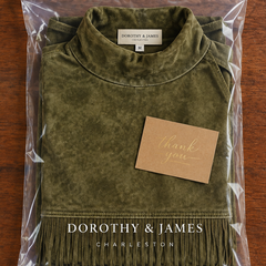 Gabriela suede fringe dress folded in Dorothy & James Charleston packaging with thank-you card
